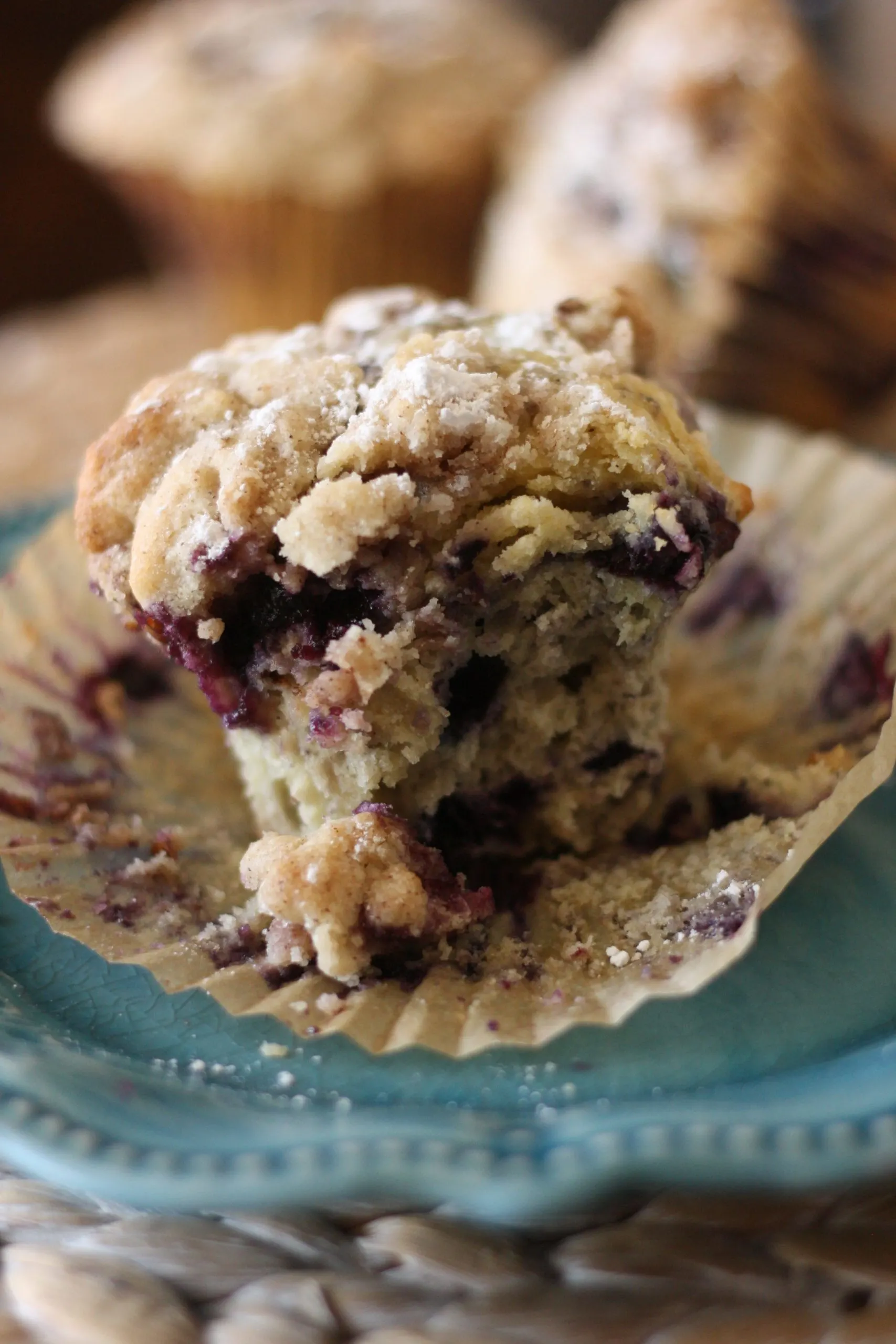blueberry crumb muffins on a blue plate