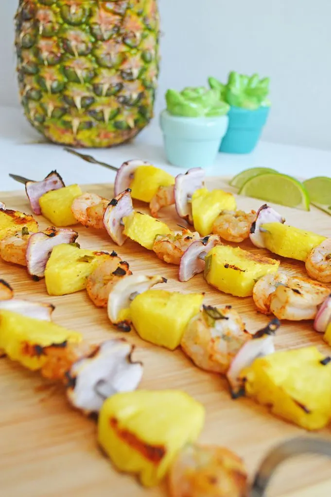 Chili Lime Pineapple & Shrimp Skewers on a cutting board