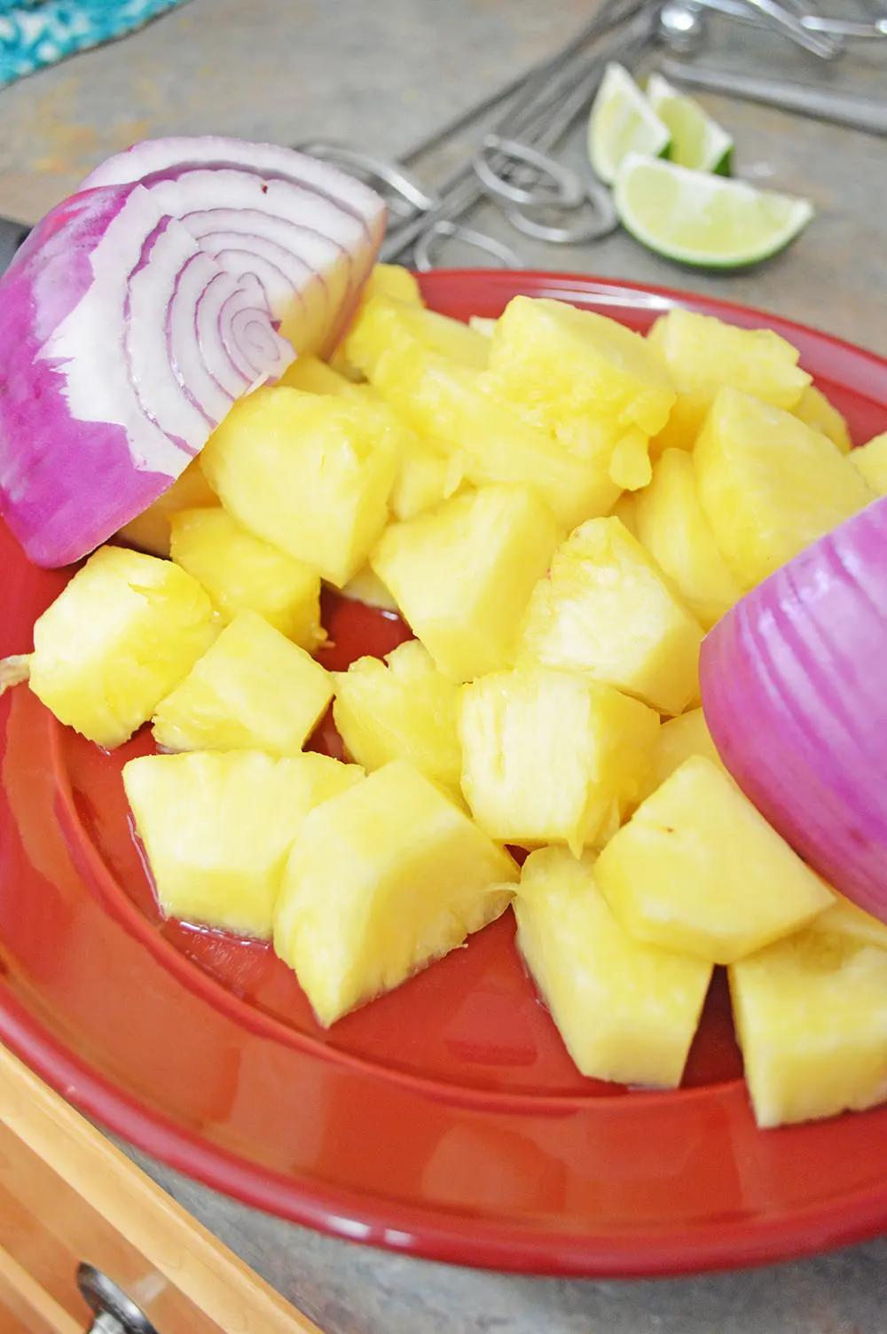 Red onion & diced pineapple in a red dish