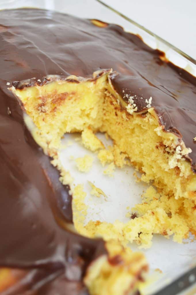 scoop out of a boston cream poke cake