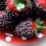 chocolate covered strawberries on a red and white polka dot plate