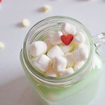 grinch white hot chocolate with marshmallows and heart candy