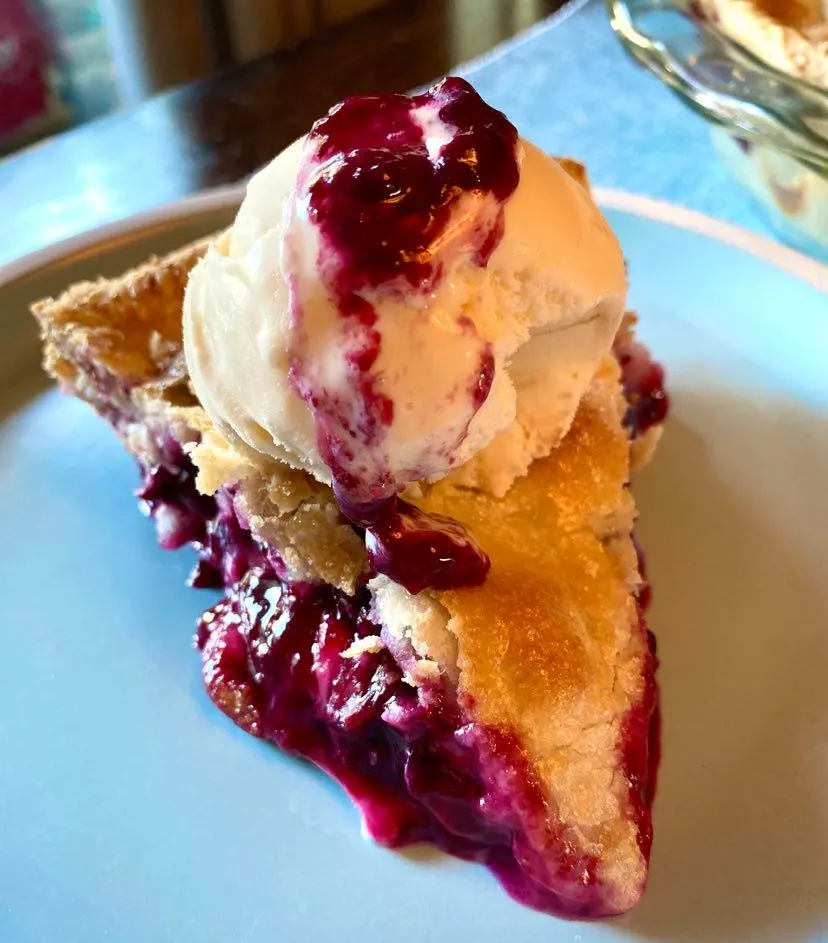 blueberry pie with vanilla ice cream on top