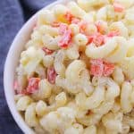 A close-up of macaroni salad with diced vegetables.