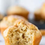 Close-up of a muffin with a bite taken out, showing a fluffy interior.