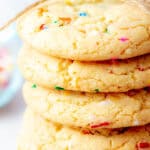 A stack of five colorful funfetti cookies tied together with twine, showing a soft and crumbly texture with small rainbow sprinkles throughout.