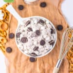 White bowl filled with cookies and cream fluff topped with mini Oreos and marshmallows.