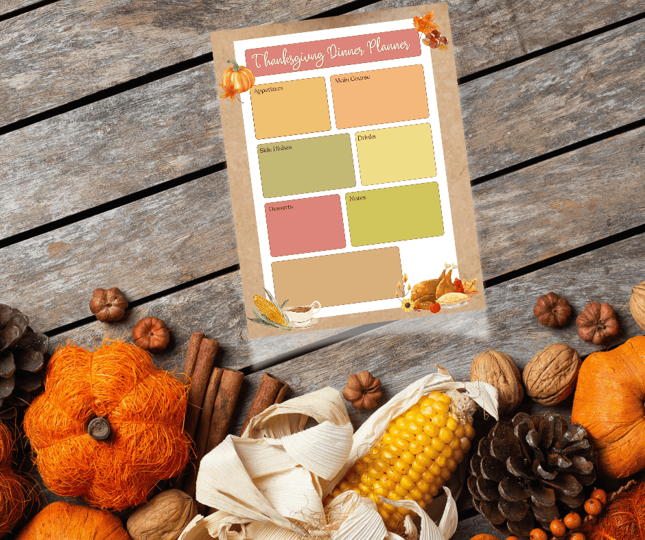 Thanksgiving dinner planner sheet on a rustic table with pumpkins, corn, pinecones, and cinnamon sticks. The thanksgiving dinner planner features sections for different meal courses in autumn colors, perfect for organizing your festive feast.