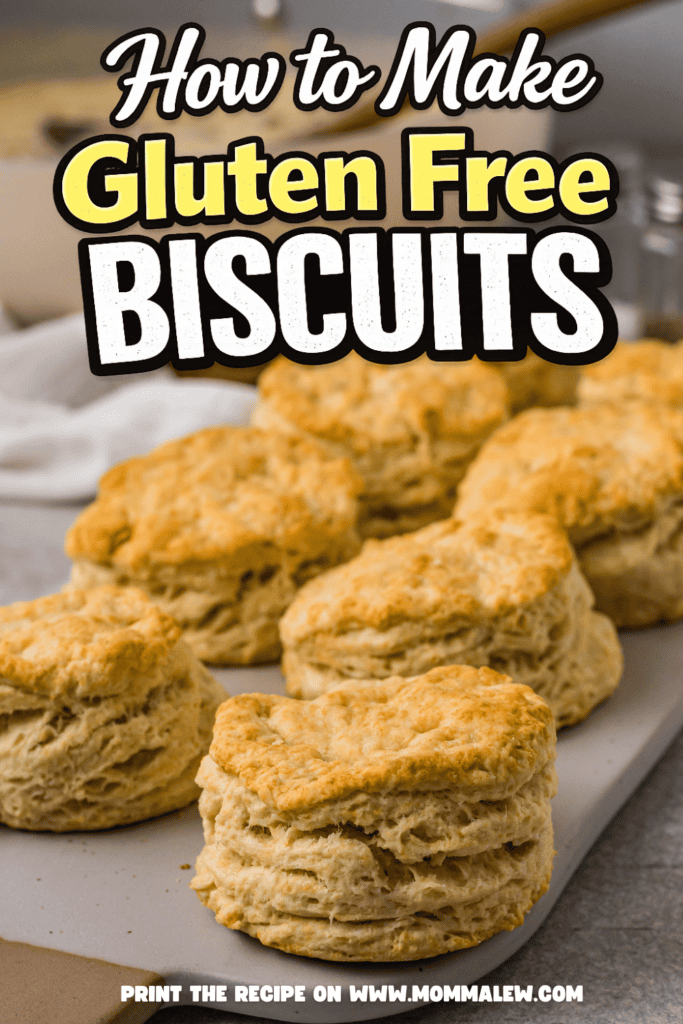 Freshly baked golden brown biscuits are arranged on a countertop. The text reads, How to Make Gluten Free Biscuits. Discover the perfect Gluten Free Biscuit Recipe and print it at www.mommalew.com.