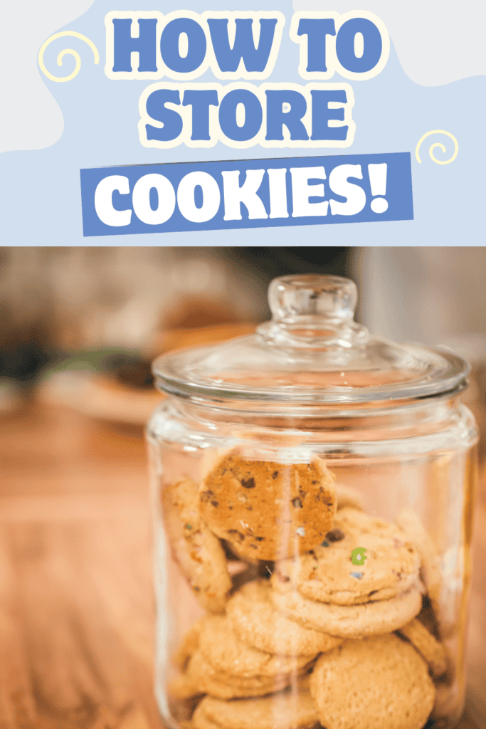 A glass jar filled with cookies sits on a wooden surface. Above the jar, a decorative sign reads “How to Store Cookies!” in bold blue and white text, offering a handy tip for anyone wondering how to store cookies properly.