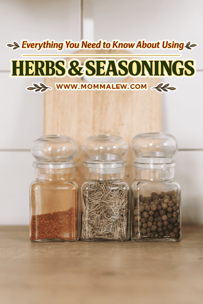 Three glass jars filled with ground spices, dried herbs, and whole peppercorns sit on a wooden surface. Above them is text reading, Everything You Need to Know About Using Herb and Seasonings.