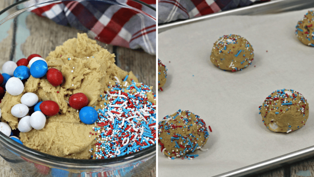 A glass bowl of cookie dough with red, white, and blue candies and sprinkles sits on a table. Next to it, Patriotic M&M Cookies dough balls with the same sprinkles are arranged on a parchment-lined baking sheet.