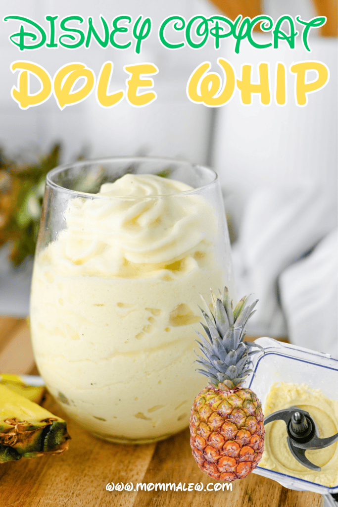 A glass filled with creamy Dole Whip sits on a wooden surface, surrounded by fresh pineapple and a small blender. The text reads Disney Dole Whip Recipe in colorful letters above the dessert.