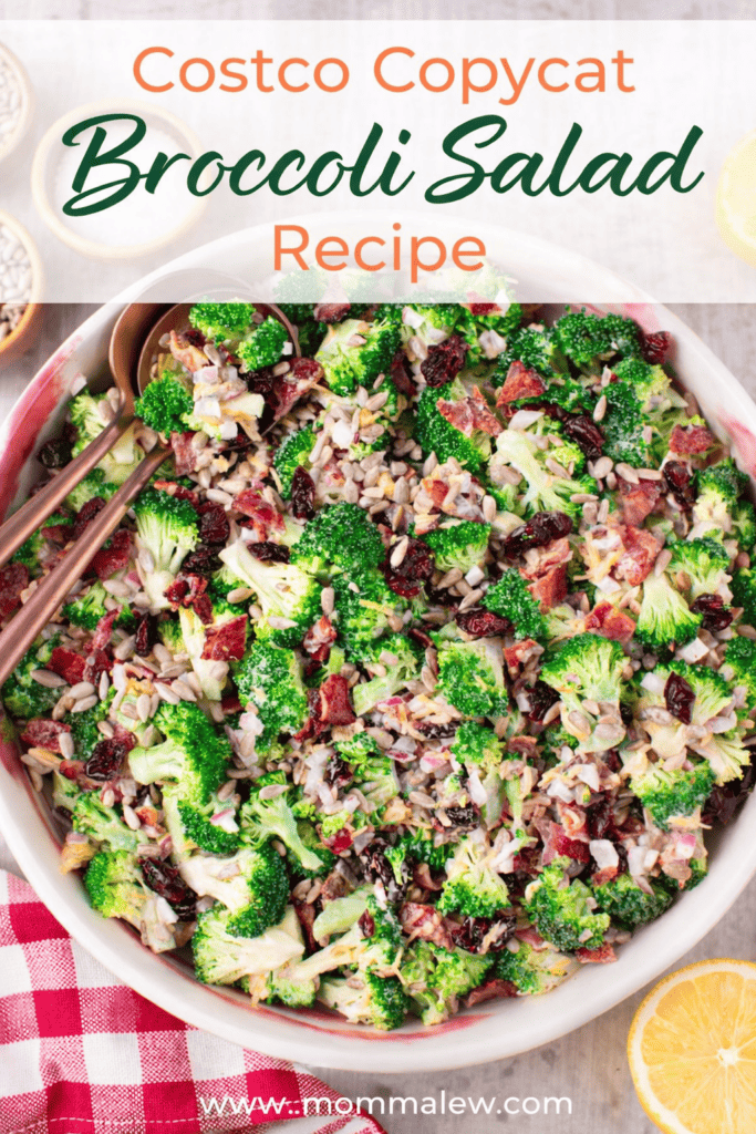 A large bowl of Costco broccoli salad with bacon, sunflower seeds, dried cranberries, and creamy dressing sits ready with serving utensils. Text overlay reads: “Costco Copycat Broccoli Salad Recipe.” A checkered napkin is beside the bowl.