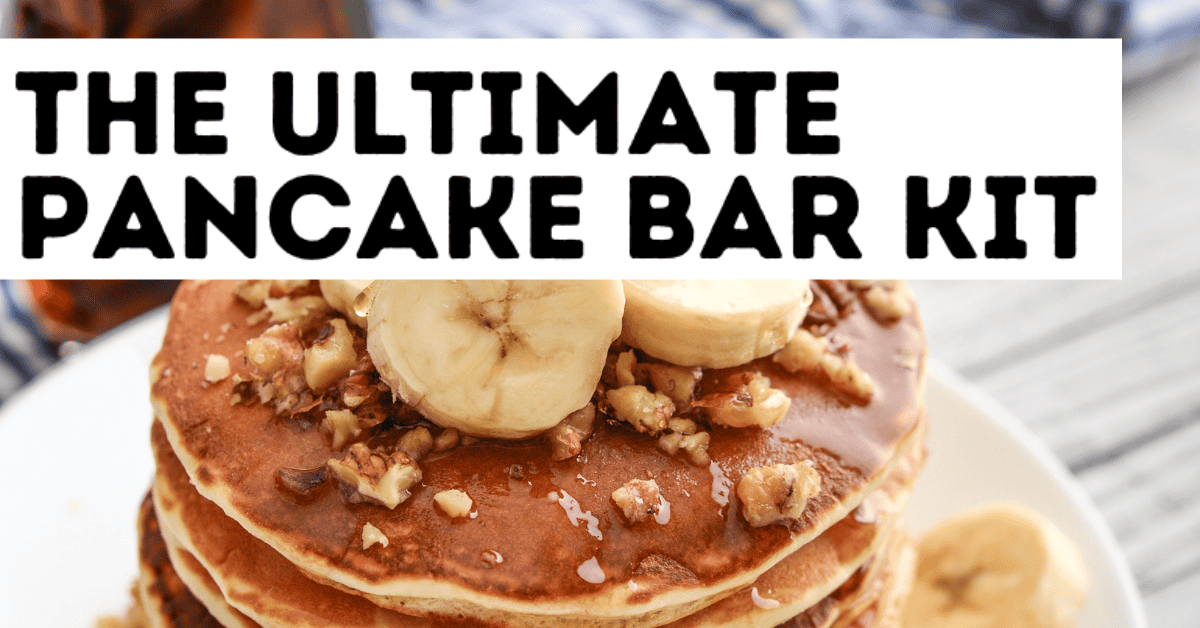 A stack of pancakes topped with banana slices and chopped nuts sits on a white plate. Overlaid text reads, THE ULTIMATE PANCAKE BAR KIT—perfect for learning How to Set Up a Pancake Bar at home.