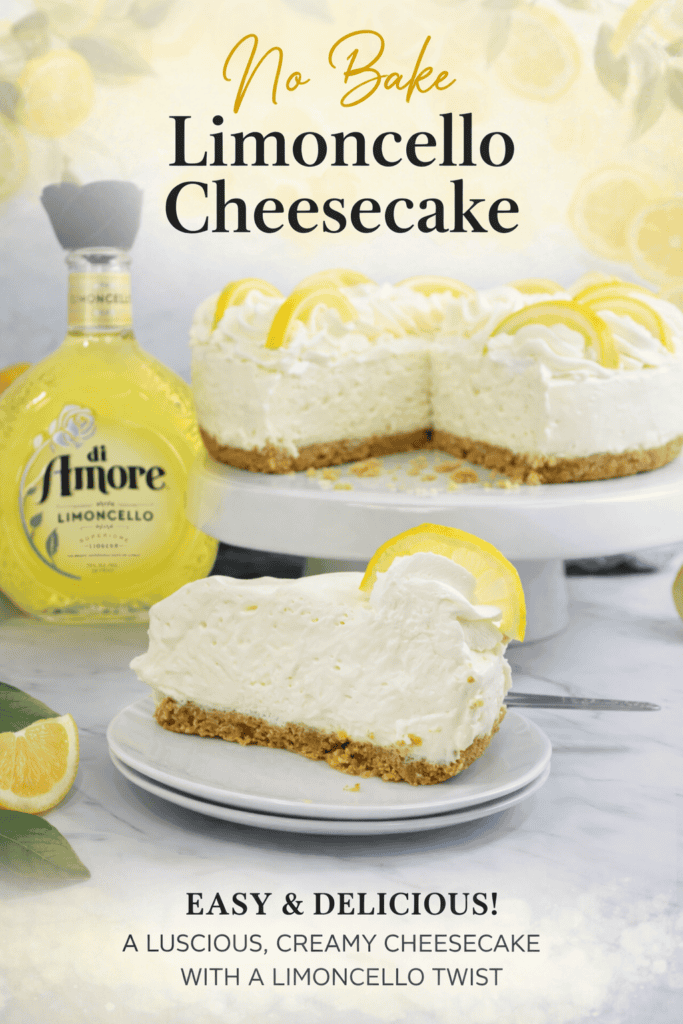 A creamy, no bake limoncello cheesecake sits on a white plate, garnished with lemon slices. Behind it are the whole cheesecake, a bottle of di Amore Limoncello, and fresh lemons. This easy and delicious limoncello cheesecake recipe is sure to impress.