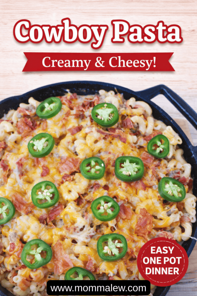 A skillet filled with cheesy macaroni pasta topped with sliced jalapeños and bacon. Text reads “Cowboy Pasta Recipe, Creamy & Cheesy!, Easy One Pot Dinner, www.mommalew.com.” The background is a light wooden surface.
