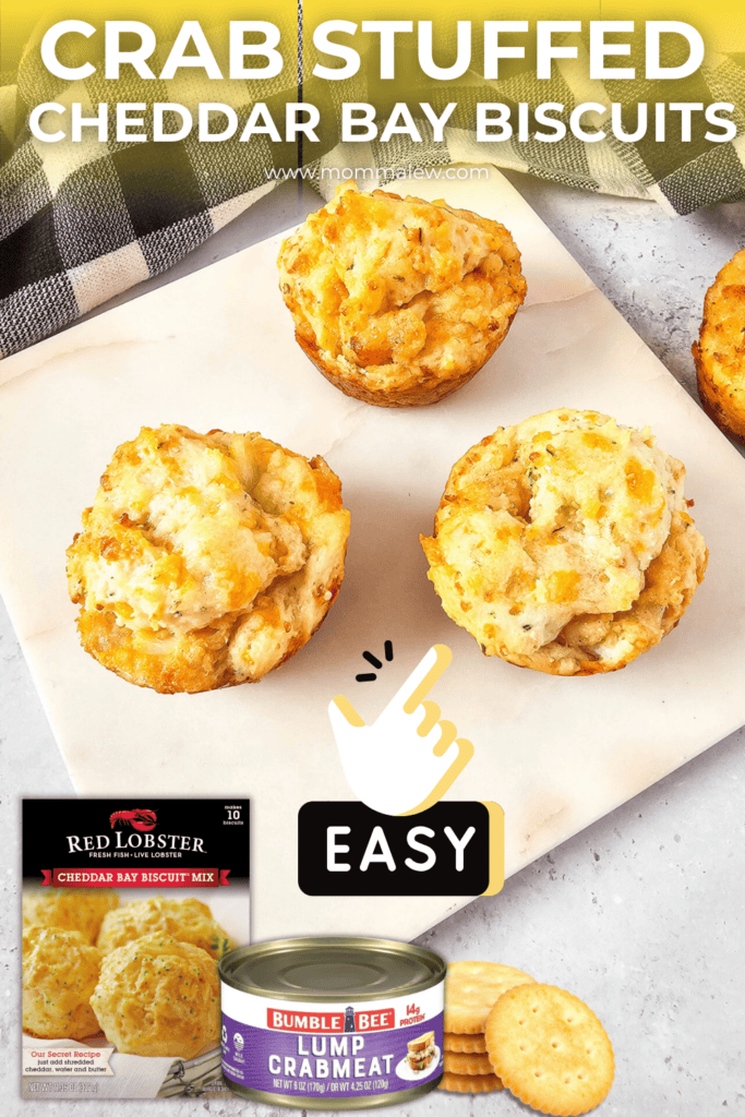 Four golden Crab stuffed Cheddar Bay biscuits sit on a marble board. Below, there’s a box of Red Lobster biscuit mix, a can of lump crabmeat, round crackers, and an “easy” label with a pointing hand.
