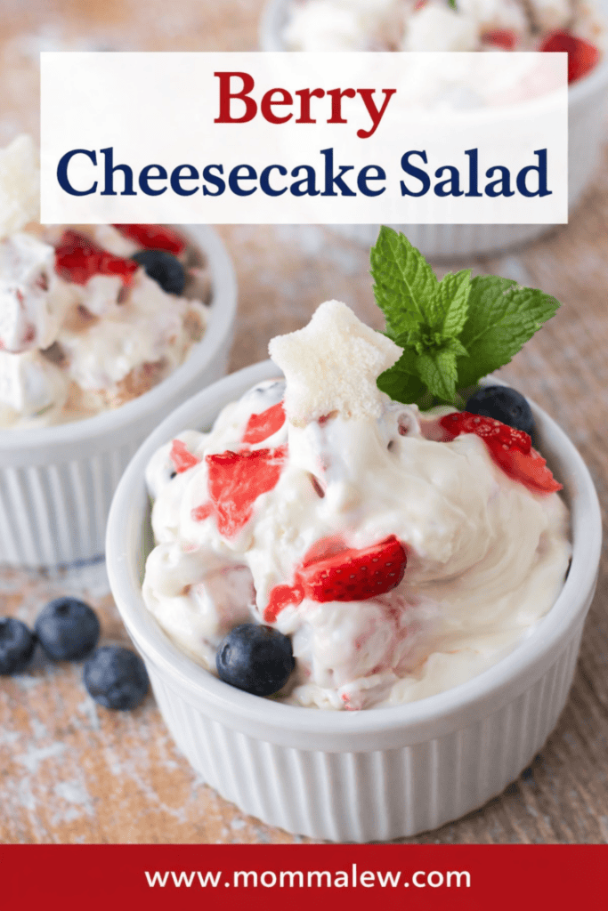 Small white ramekins filled with creamy Very Berry Cheesecake Salad, topped with strawberries, blueberries, a mint sprig, and a star-shaped fruit slice. Text reads “Berry Cheesecake Salad” and “www.mommalew.com.”.