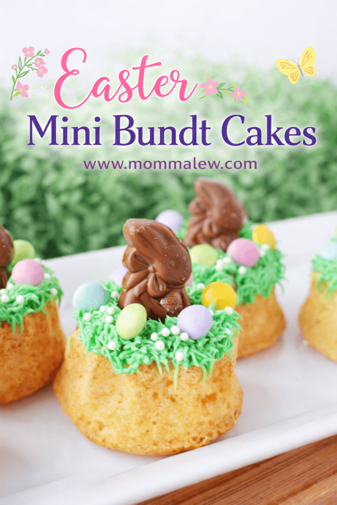 Easter Mini Bundt Cakes decorated with green frosting, pastel candy eggs, and a chocolate bunny on top; text reads Easter Mini Bundt Cakes www.mommalew.com, surrounded by flowers and butterflies.
