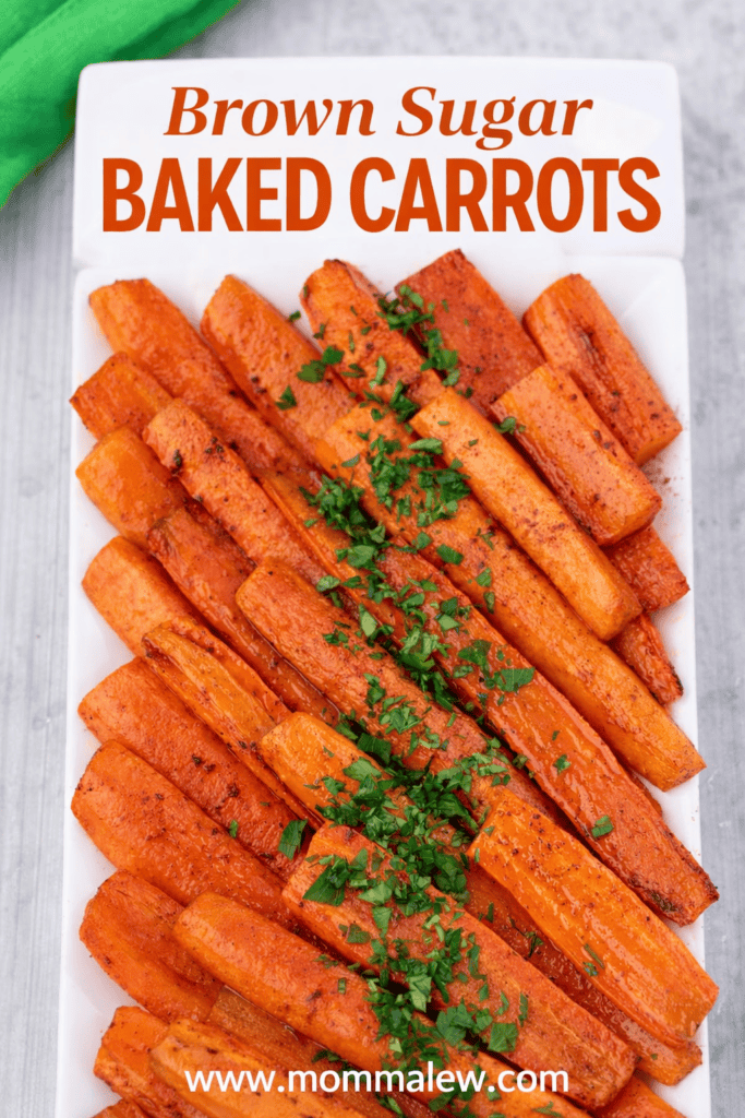A rectangular white plate filled with Baked Carrots with Brown Sugar, garnished with chopped herbs. The text Brown Sugar Baked Carrots appears at the top, and www.mommalew.com is at the bottom.