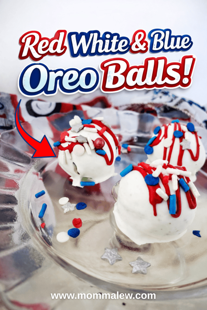 Three Red White Blue Oreo Balls, dipped in white chocolate and topped with festive sprinkles and drizzle, sit on a clear glass plate. Text above reads Red White & Blue Oreo Balls! with mommalew.com featured at the bottom.