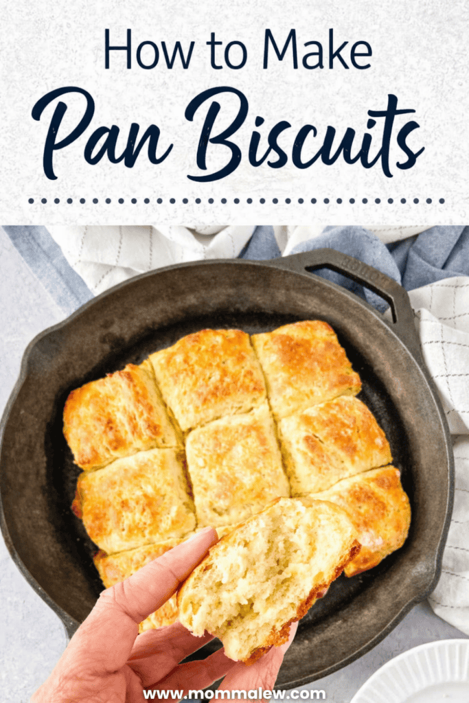 A hand holds a split, fluffy pan biscuit above a cast iron skillet filled with golden-brown pan biscuits. The text reads, How to Make Pan Biscuits, with the website www.mommaleew.com below.