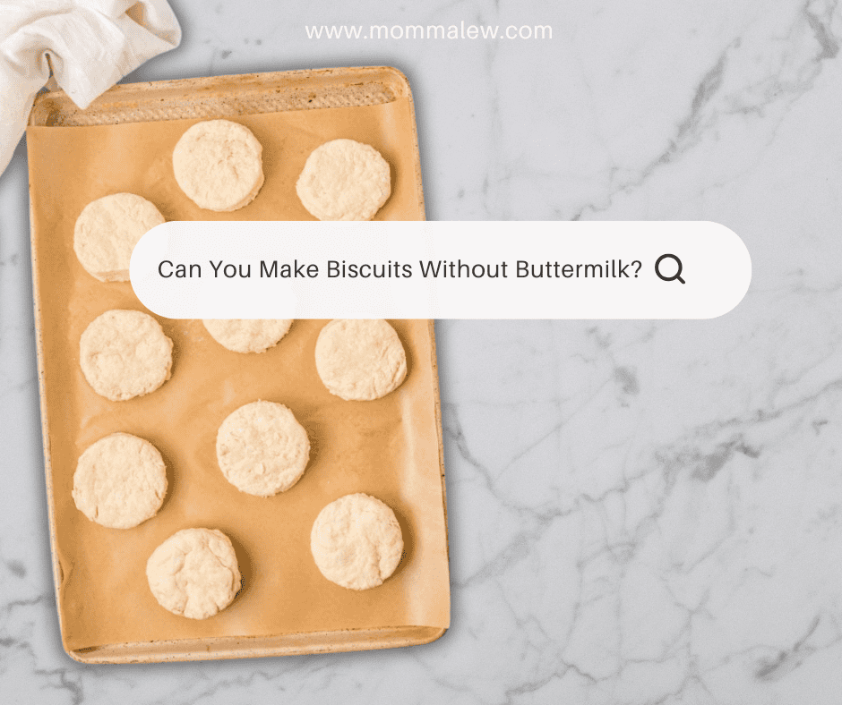 A baking sheet with nine unbaked biscuits on parchment paper sits on a marble countertop. A search bar overlay asks, Can you make biscuits without buttermilk?.