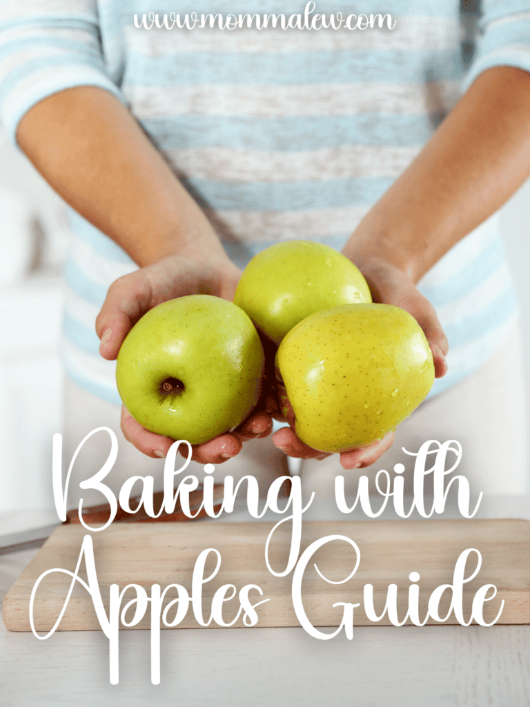 A person in a striped shirt holds three green apples over a wooden cutting board. White text reads, Best Apples for Baking: Baking with Apples Guide. The website www.mommalew.com is at the top.