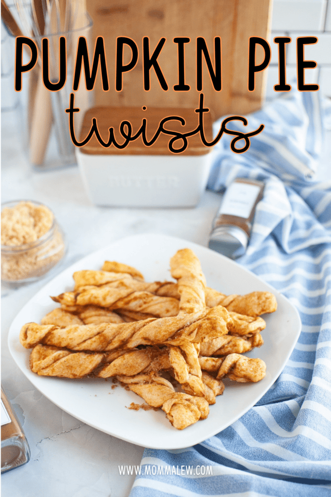 A white plate with Pumpkin Pie Twists sits on a blue striped cloth, their golden spirals invitingly crisp. In the background, a butter dish, brown sugar, and a spice jar hint at the delicious flavors inside. Text reads Pumpkin Pie Twists.